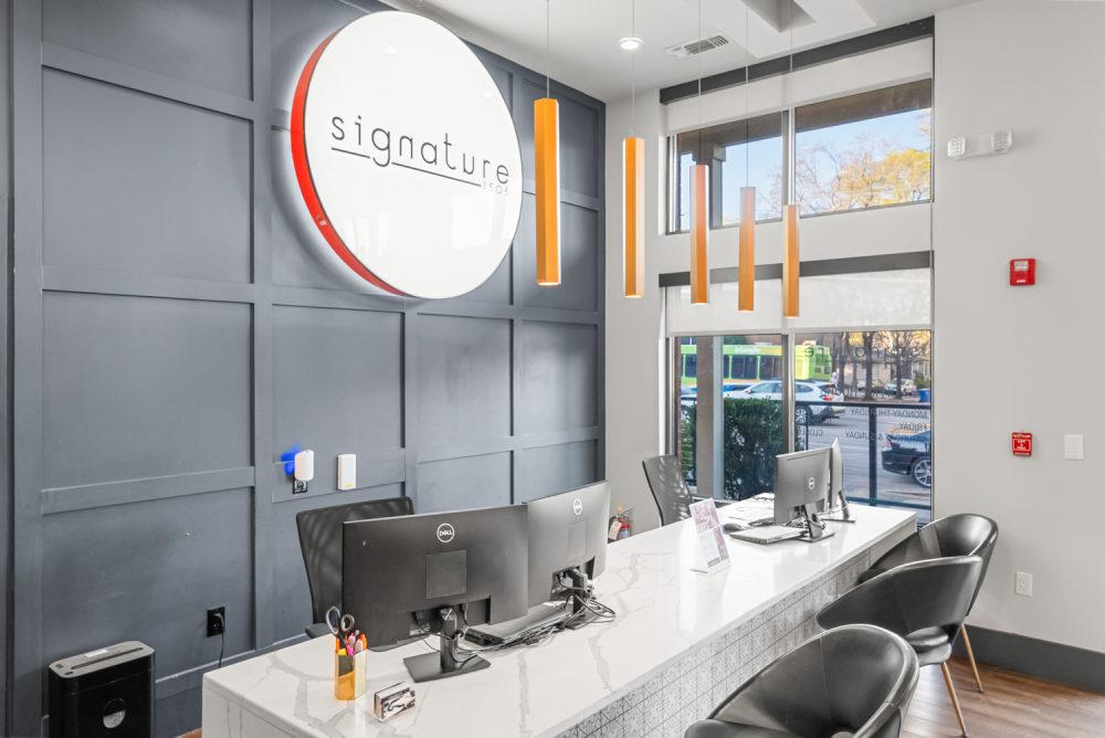 signature 1505 apartments near nc state university leasing office desk