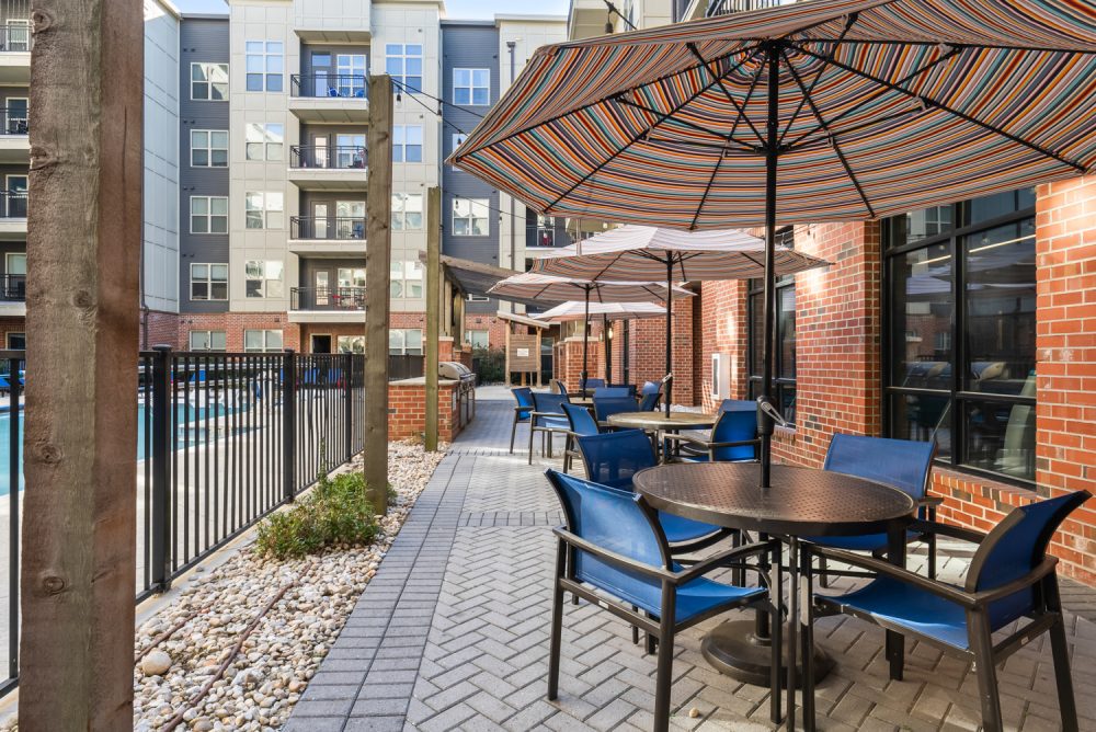 signature 1505 apartments near nc state university poolside tables